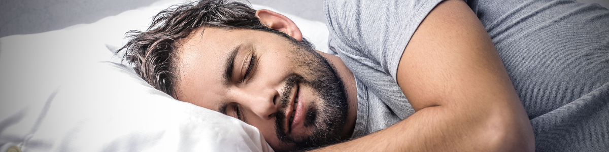 Person preparing for bed at 9:00 PM as part of a pre-sleep routine to improve sleep quality and align with optimal sleep timing.